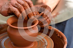 Potter making ceramic pot on the pottery wheel