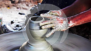 Hands of a potter. Potter making mud ceramic pot on the pottery wheel