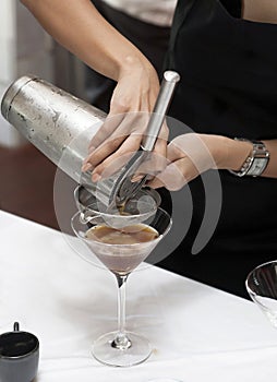 Hands pouring cocktail