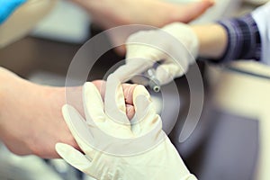 Hands practicing chiropody taking care of feet