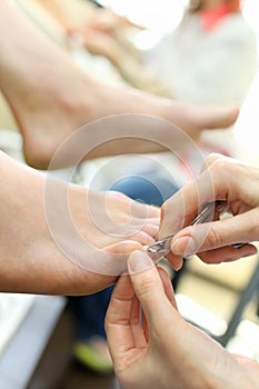 Hands practicing chiropody taking care of feet photo