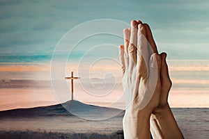 Hands in pray against Easter cross and sunset landscape. Copy space. Shining cross on Calvary hill, sunrise sky
