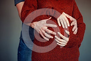 Hands on pregnant abdomen