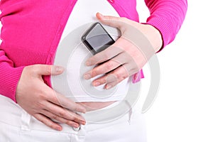 Hands of pregnant woman holding phone near abdomen