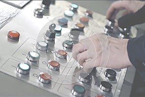 Hands pressing buttons on the control panel