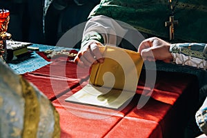 The hands of the priests and blessed altar cloth in the altar of the church