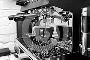 Hands of professional barista standing near the big metal coffee