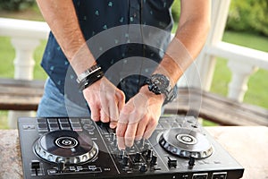 Hands of a professional DJ on the controller mix music