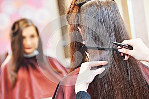 Hands of professional hair stylist with scissors and comb