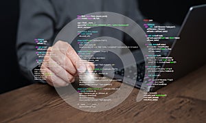 Hands of a programmer types on a laptop displaying programming code, symbolizing coding tech, software development, web