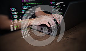 Hands of a programmer types on a laptop displaying programming code, symbolizing coding tech, software development, web