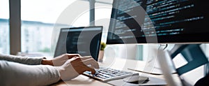 The hands of a programmer typing code on a keyboard in a modern workspace. AI generated image