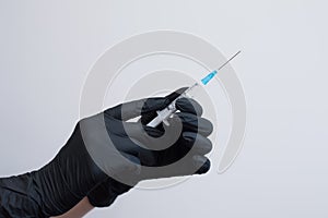 Hands in protective gloves with a syringe and antiseptics