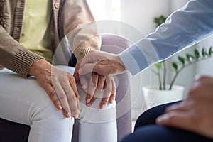 The hands of a psychiatrist hold the patient hand to encourage and encourage recovery from depression