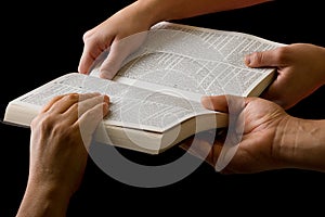 Hands Pulling a Bible