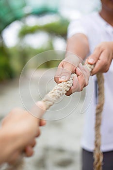 Hands pulling rope