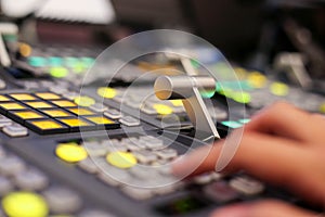 Hands push a button of Switcher buttons in studio TV station, Au