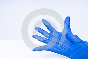 Hands putting on blue nitril gloves
