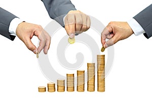 Hands putting coins to stacks of coins photo