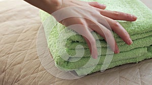 Hands putting green towels