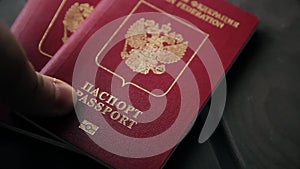 Hands putting the passport of Russian federation