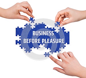 Hands with puzzle making BUSINESS BEFORE PLEASURE word