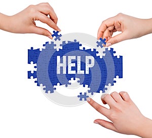 Hands with puzzle making HELP word