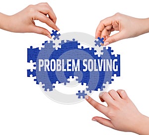 Hands with puzzle making PROBLEM SOLVING word