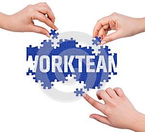 Hands with puzzle making WORKTEAM word photo