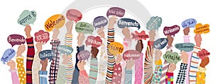 Hands raised of children holding speech bubbles with text Welcome in international languages