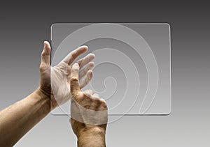 Hands reaching images on a futuristic tablet