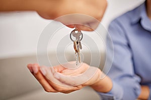 Hands, real estate and giving keys to customer after moving into new home. Property agent, realtor and handing over key