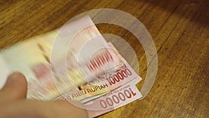 Hands are recalculated and put on the table Indonesian rupee