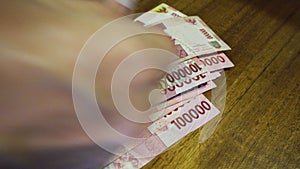 Hands are recalculated and put on the table Indonesian rupee