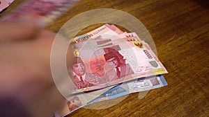 Hands are recalculated and put on the table Indonesian rupee