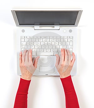 Hands in red jacket and white laptop