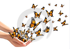 Hands releasing butterflies.
