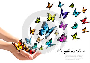 Hands releasing colorful butterflies.