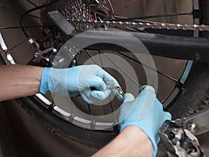 Hands reparing the chain of a bicycle
