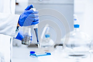 Hands of a researcher carrying out experiment