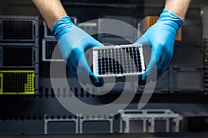 Hands of a researcher carrying out research experiment in a chemistry lab