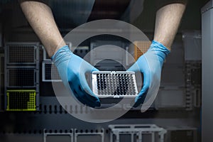 Hands of a researcher carrying out research experiment in a chemistry lab