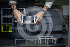 Hands of a researcher carrying out research experiment in a chemistry lab