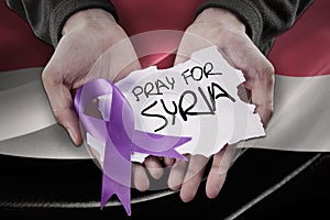 Hands with ribbon and pray for Syria