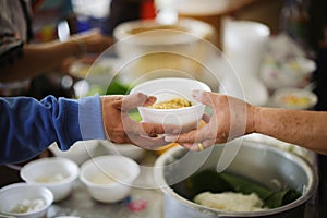 The hands of the rich give food to the hands of the poor : Social Problems of Poverty Helped by Feeding : Concepts problems of photo