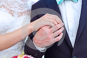 Hands with rings of the bride and groom