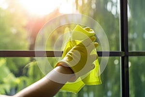 Hands in rubber gloves cleaning the window pane with detergent concept. Generative AI