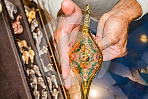 Hands rubbing on alladin lamp