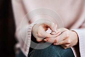 The hands say what the heart feels. Cropped shot of a woman sitting on a sofa and feeling anxious.