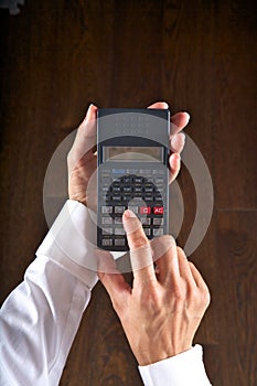 Hands with scientific calculator